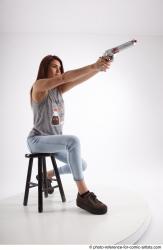 Woman Adult Athletic White Fighting without gun Sitting poses Casual